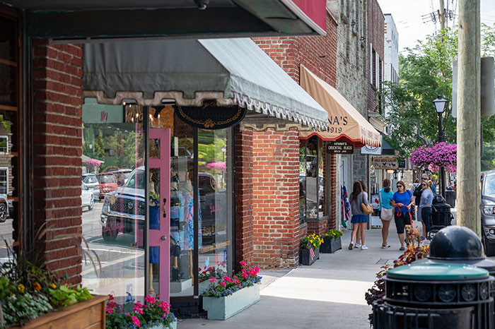small storefronts with people walking along the street in Blowing Rock