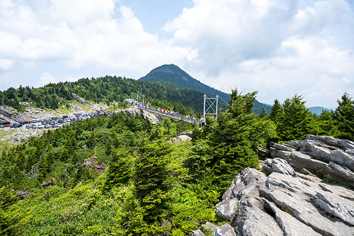 Grandfather mountain from a distance with a famous walking bridge in the foreground.